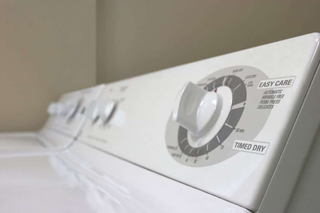 A close-up of a washing machine dial set to the "Easy Care" and "Timed Dry" cycles.